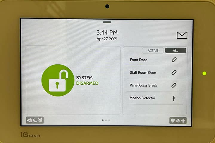 Alarm system touchscreen panel showing the system disarmed
